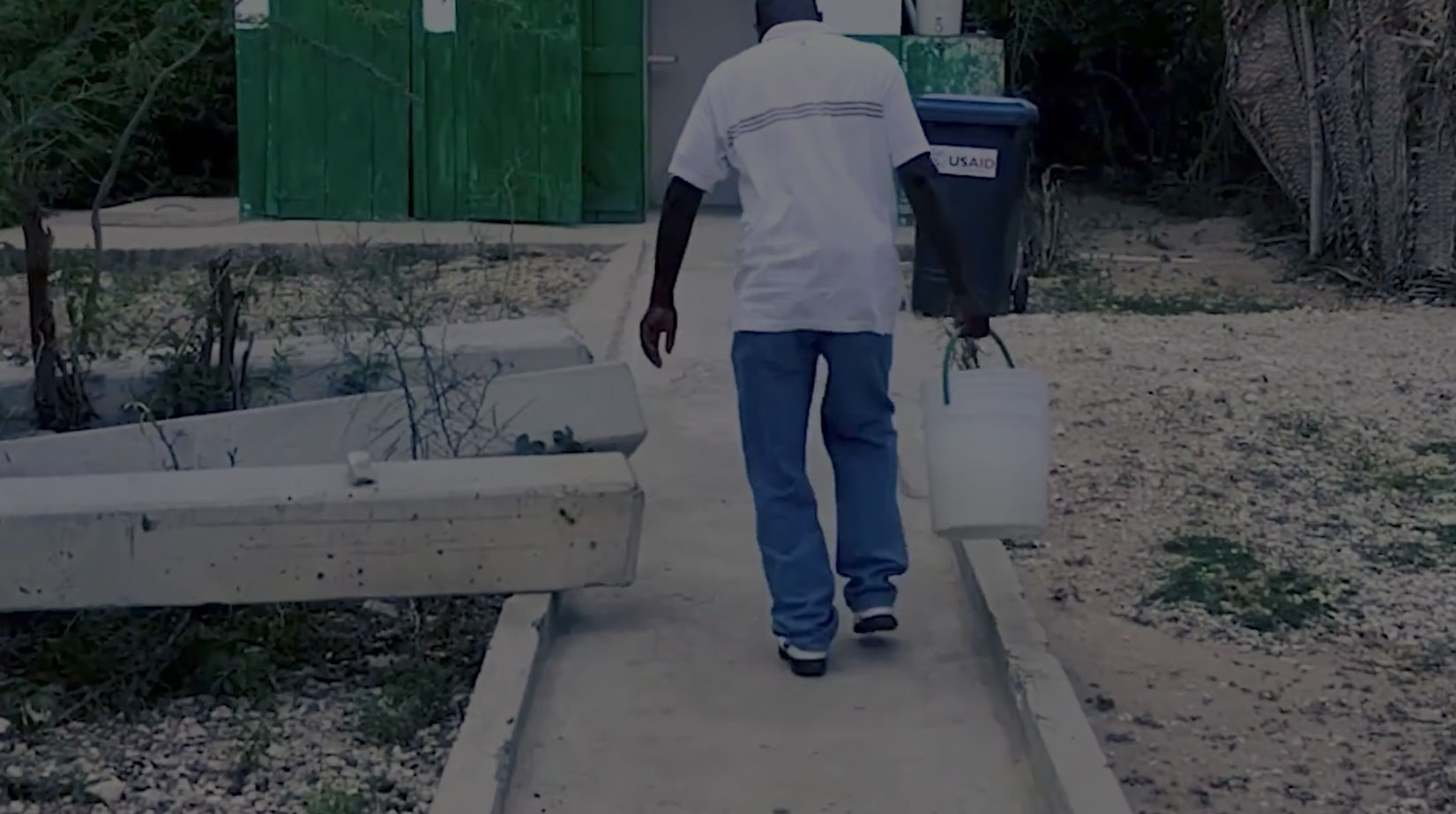 A man carrying a bucket of water